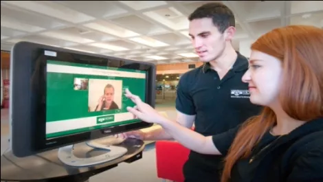 Kiosk user demonstrating touch screen